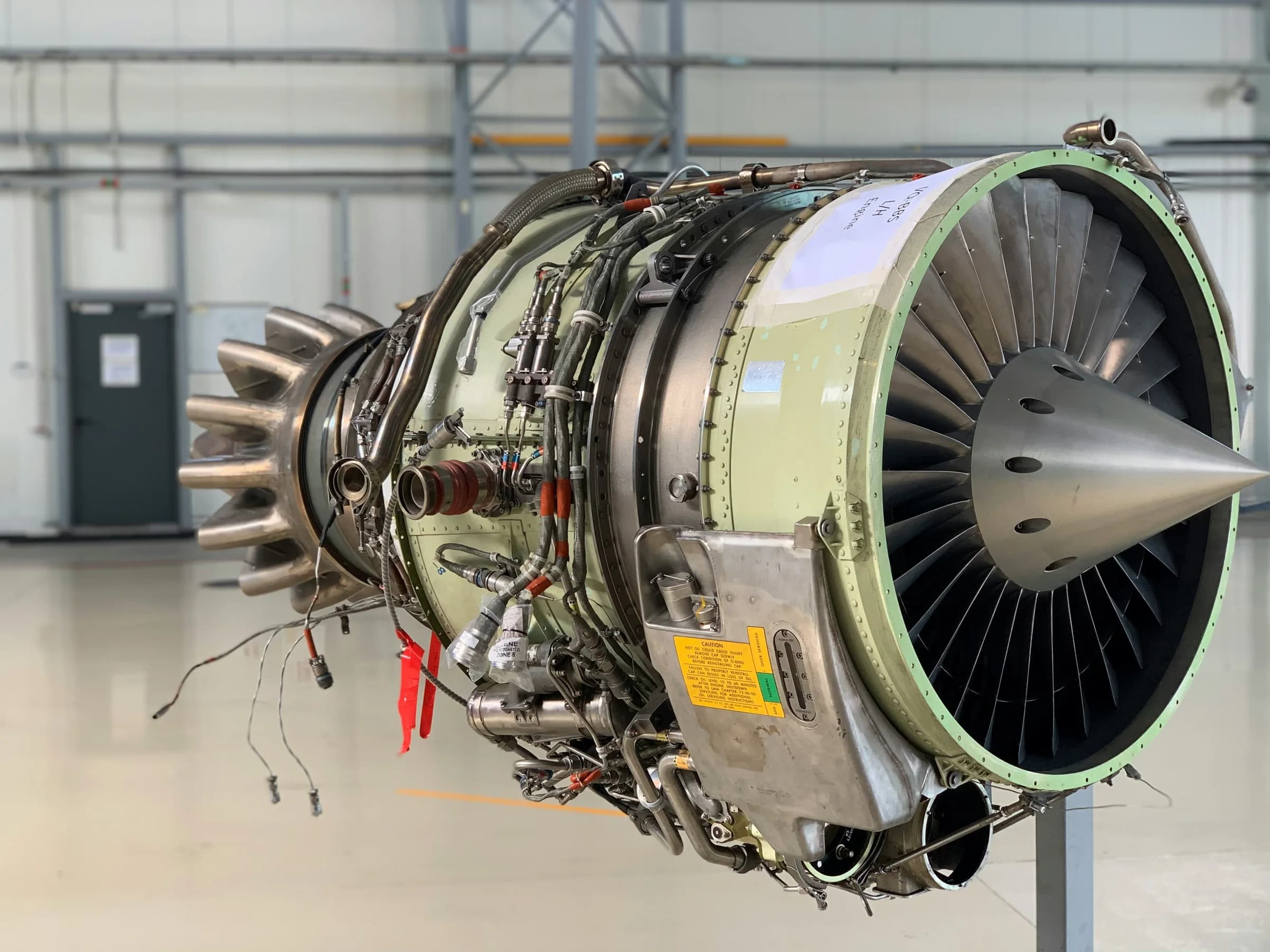 An exposed aircraft engine in a maintenance hangar
